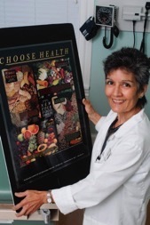 Doctor Ana Negron standing with a poster